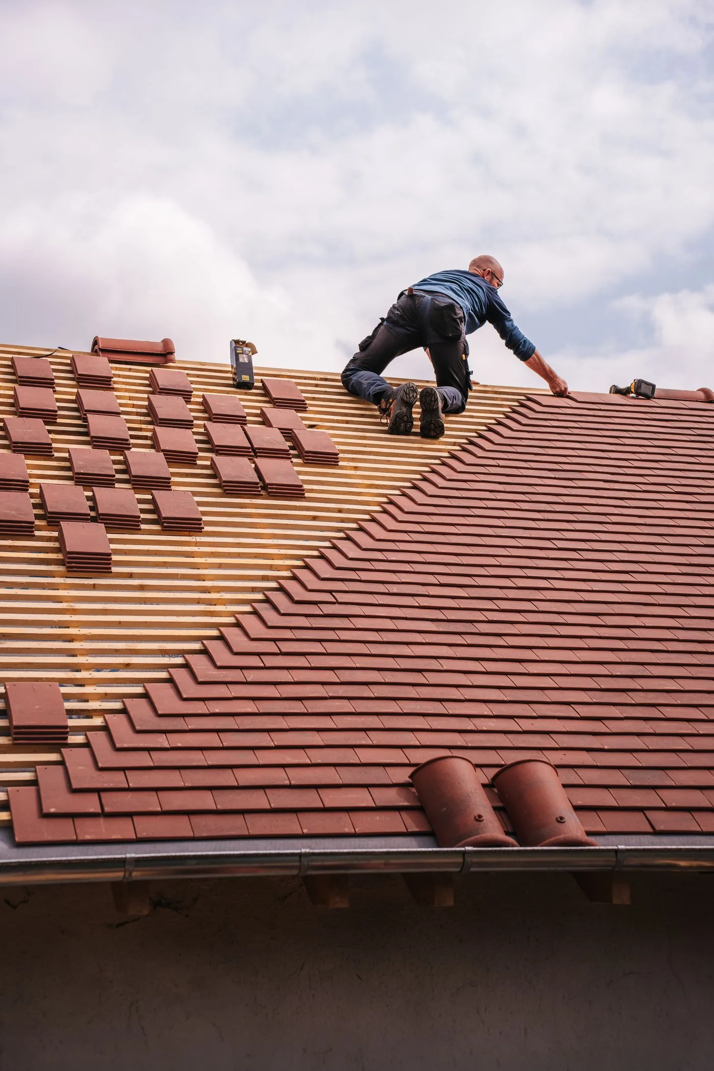 Roofing technician documenting storm damage