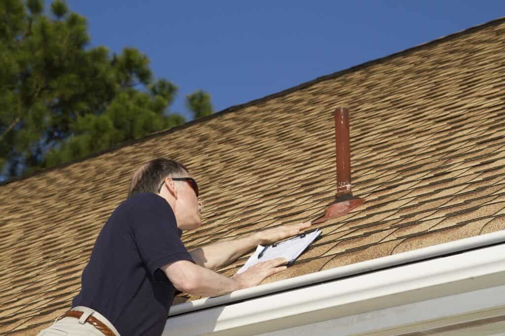 man inspecting the roof