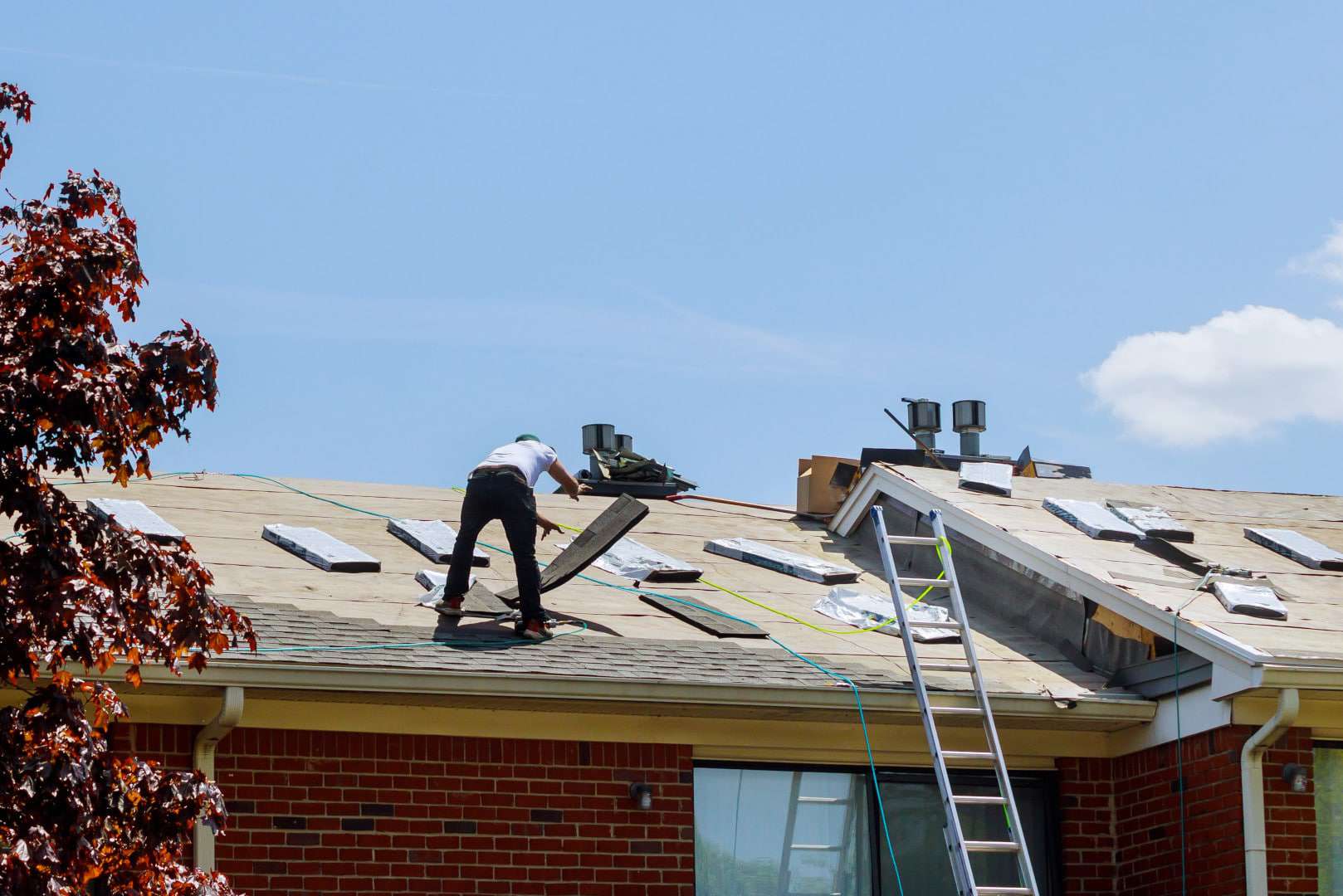 roofers on a roof doing roofing
