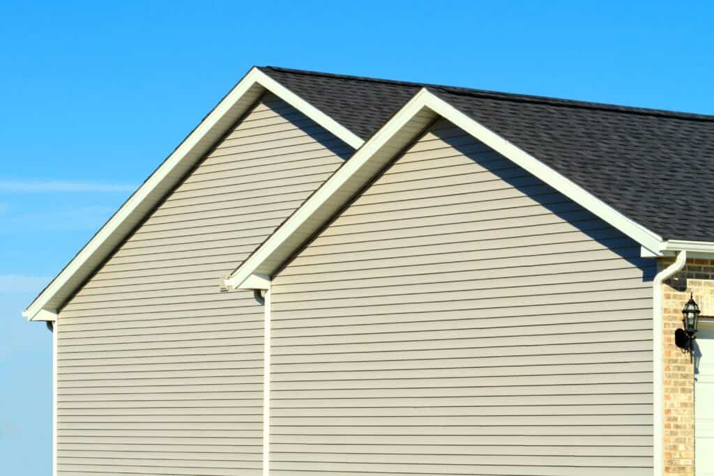 a Close up of a side of a house showing its completed siding 