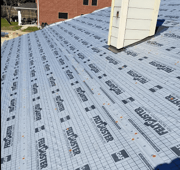 Underlayment being showed on a new roof replacement in Minneapolis 