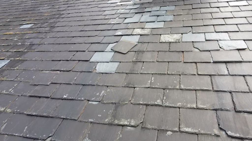 Close up of roof damage, shingles out of place roof repairs are needed