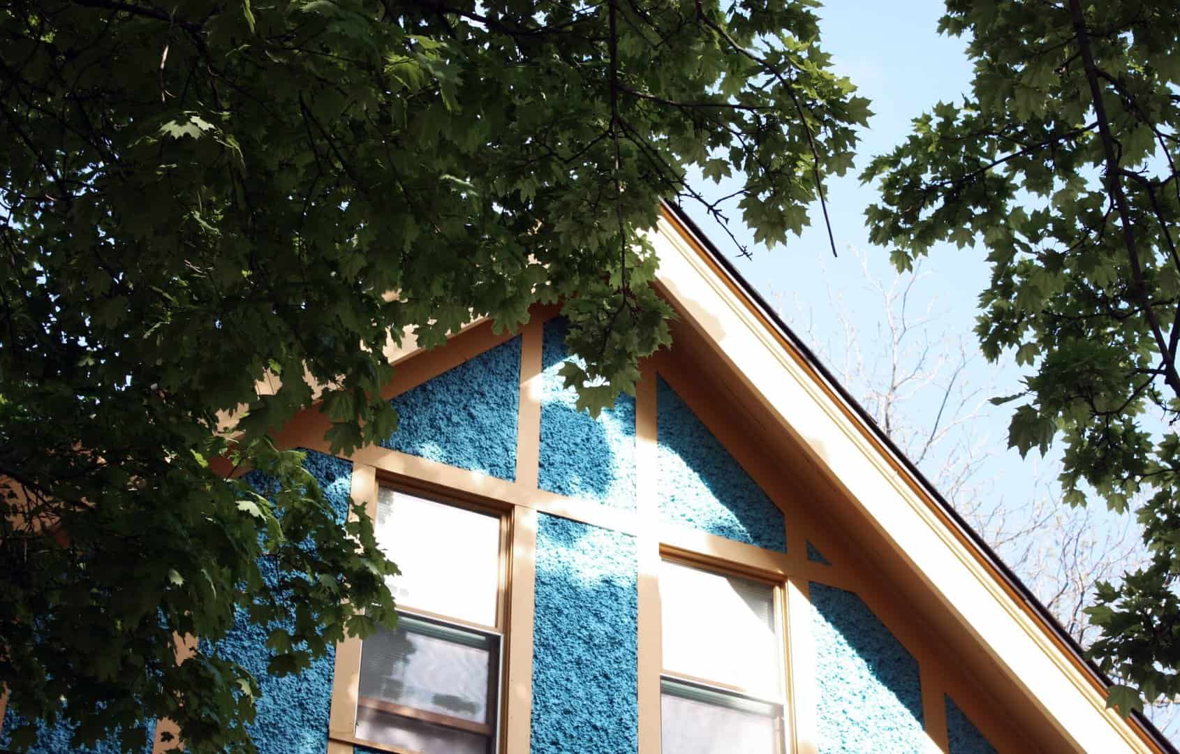 cropped image of top of pitched roof house after roof installation by minneapolis roofing company