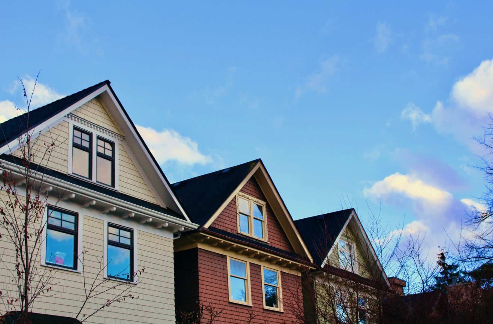 Top of three homes with different siding installation by minneapolis roofing company