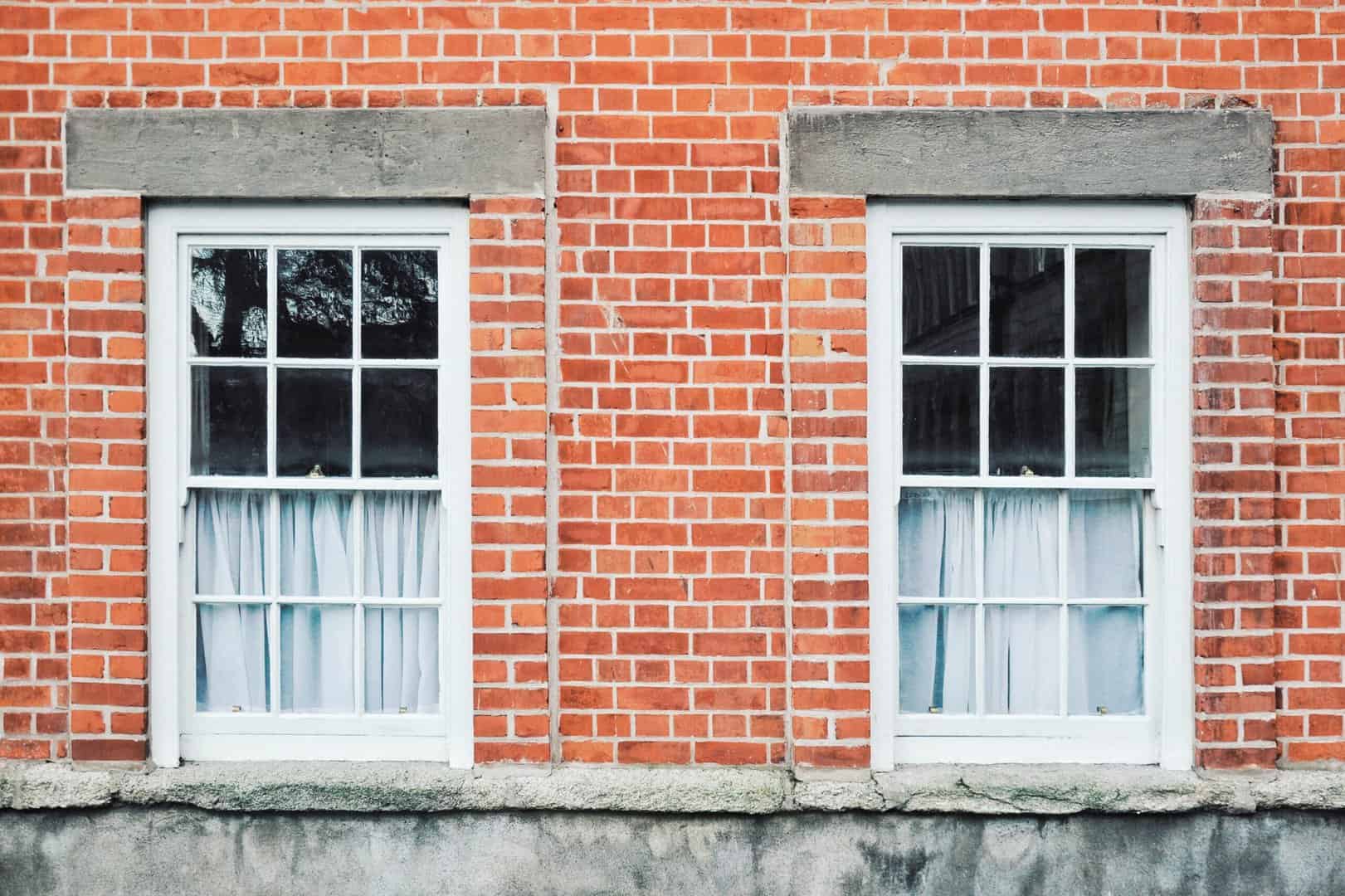 Two windows in a brick building.