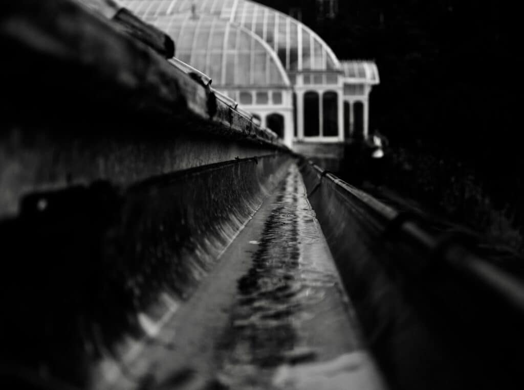 black and white image of the inside of a half round gutter installation in Minneapolis