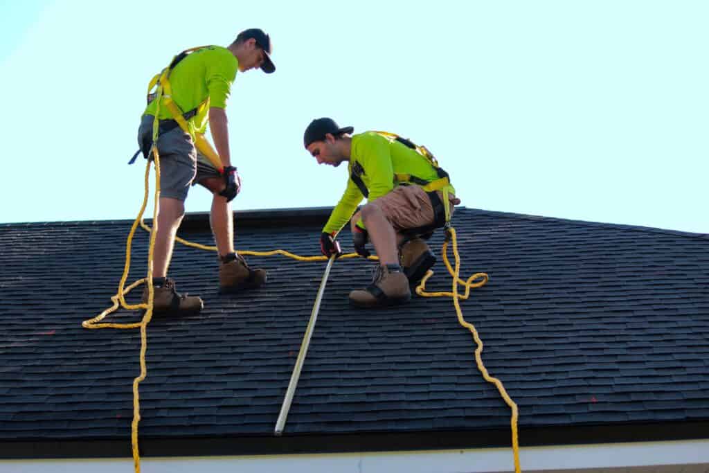 Two roofing contractors performing maintenance on a Minneapolis roof.