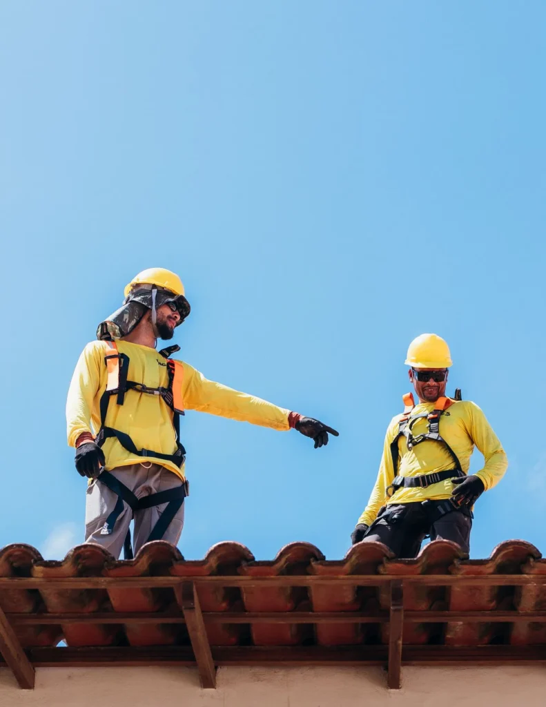 Roofing professionals working on a local roof